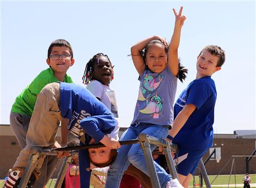 Shoemaker Elementary students smiling on the playground